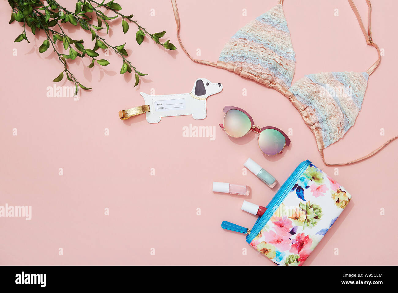 Young woman beach holiday fashion and beauty products and accessories flat lay on pink background Stock Photo