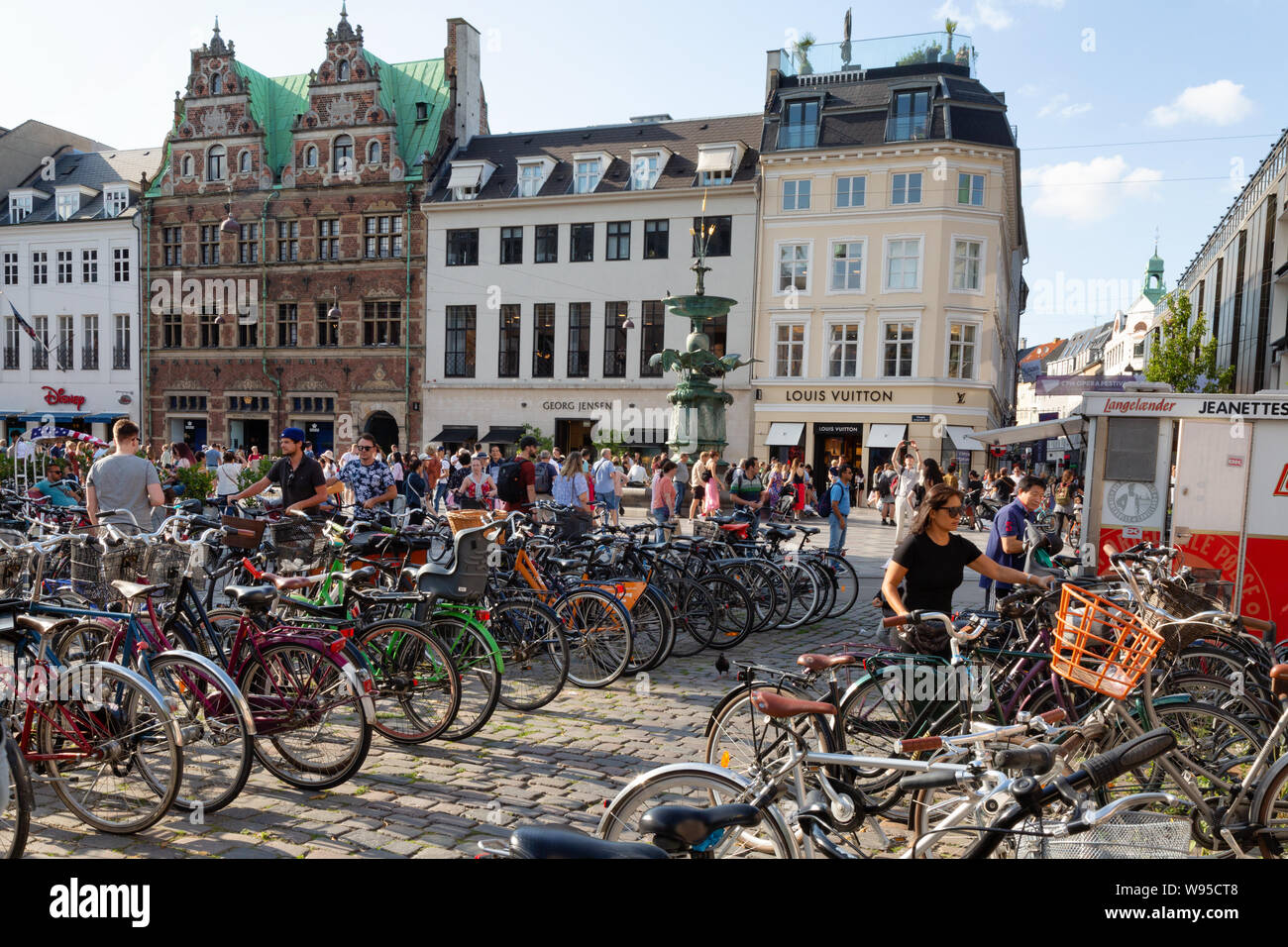 Copenhagen bikes - people parking bicycles in a cycle park on Strogets, example Danish lifestyle; Copenhagen Denmark Scandinavia Europe Stock Photo