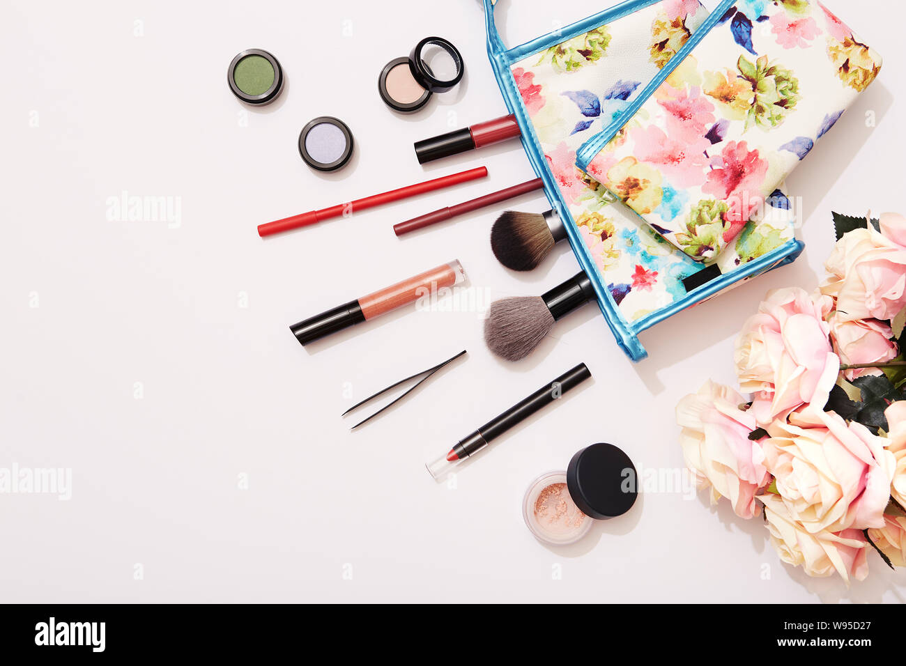 Summer beauty makeup products on white background with roses Stock Photo