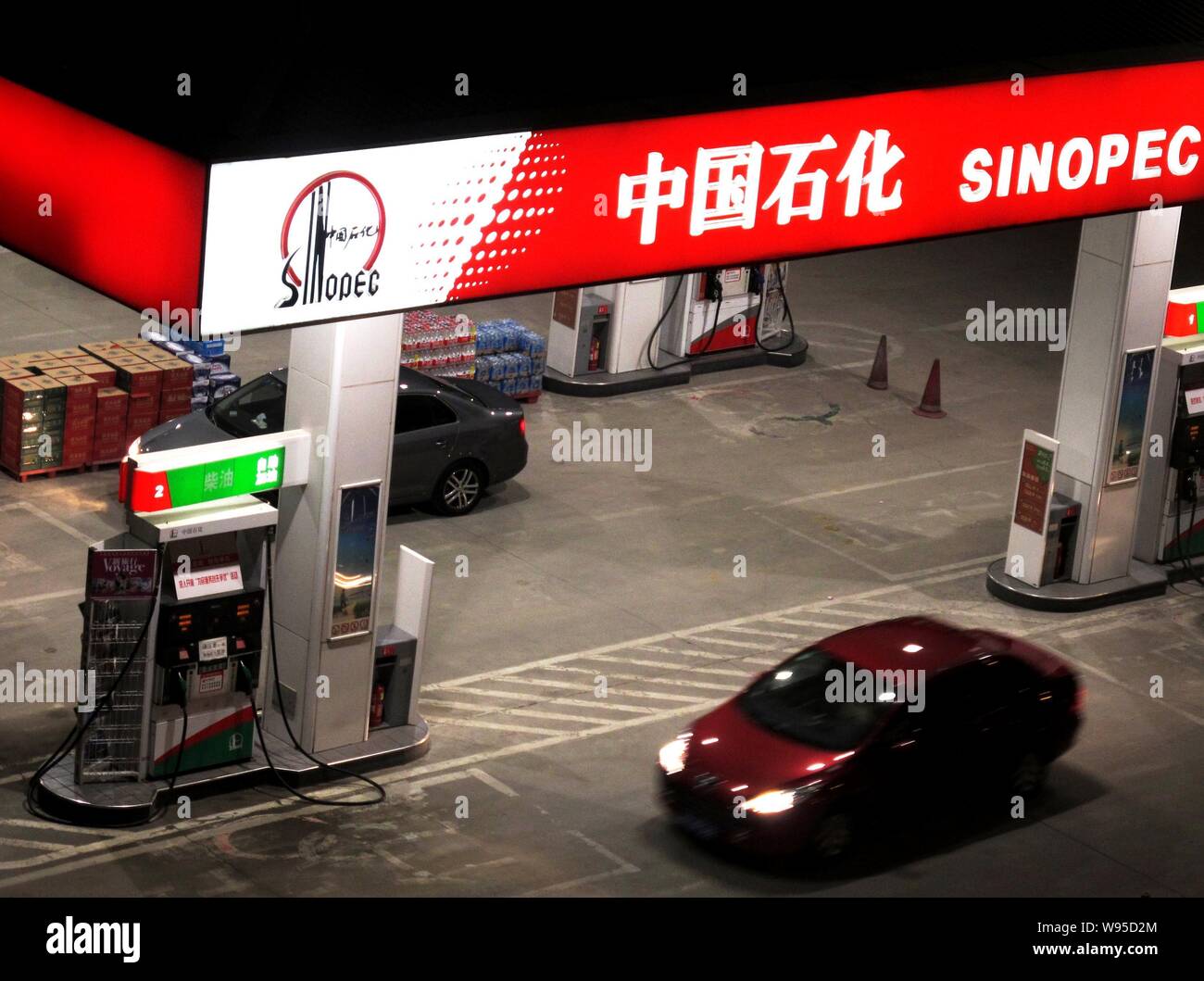 --File--Cars drive through a gas station of Sinopec in Beijing, China, 24 March 2012.   China Petrochemical Corp., the state- owned petroleum explorer Stock Photo