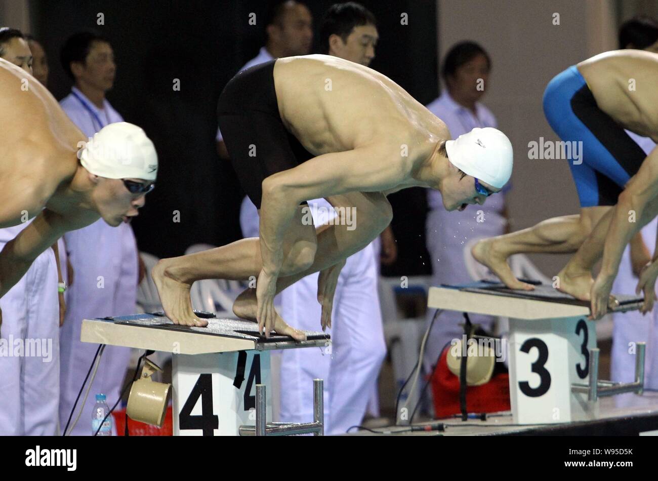Chinese Olympic swimming champion Sun Yang, center, prepares to jump ...