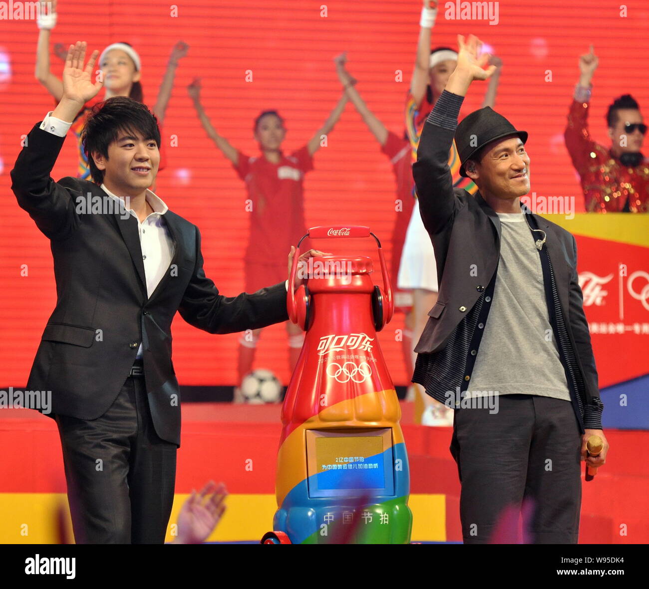 Chinese pianist Lang Lang, left, and Hong Kong singer Jacky Cheung, right, wave during a ceremony by Coca-Cola to release an Olympic theme song at the Stock Photo
