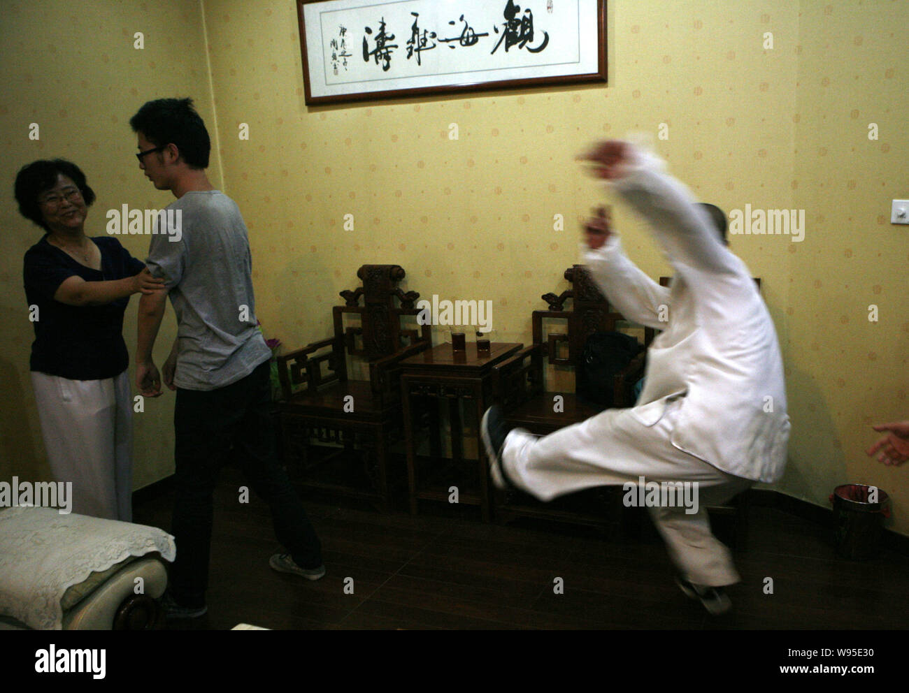 Chinese Tai Chi master Yan Fang (L) demonstrates Pushing Hands, a traditional Tai Chi techinque, in which the challengers are knocked back for a coupl Stock Photo