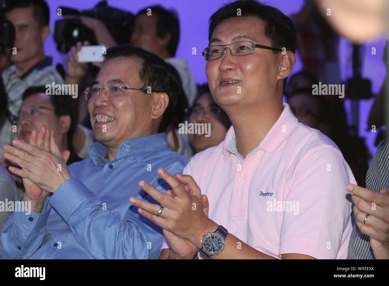 Pony Ma (Ma Huateng), right, Chairman and CEO of Tencent, and Li Dongsheng, left, Chairman of TCL, applaud at a launch ceremony for the TCL smart TV, Stock Photo
