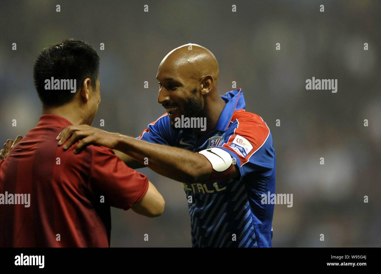 Shanghai Shenhuas French striker Nicolas Anelka talks with the referee during the sixth round of Chinese Super League against Tianjin Teda in Shanghai Stock Photo