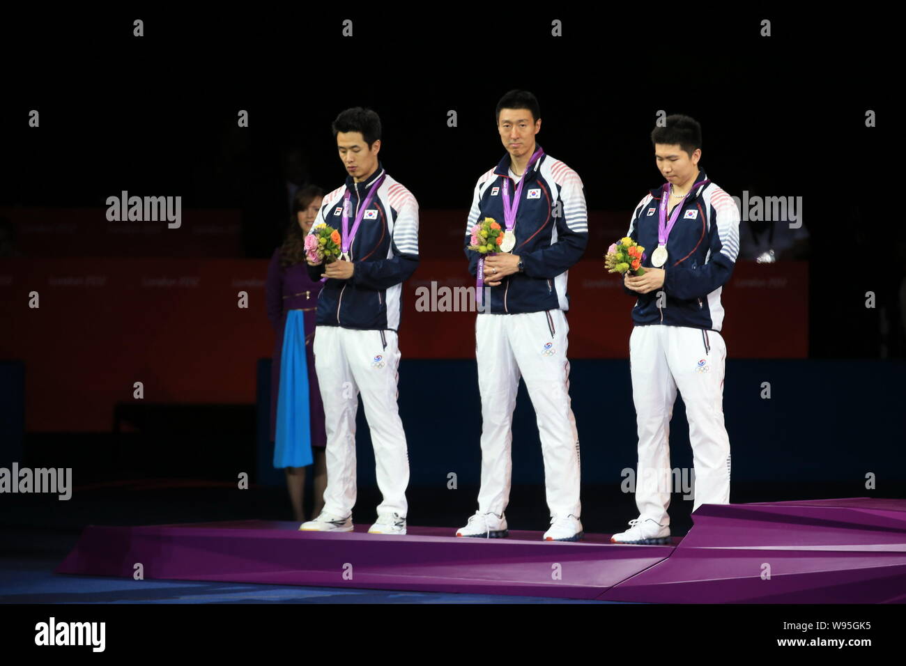 Silver medalists of South Korea pose on the podium in the award
