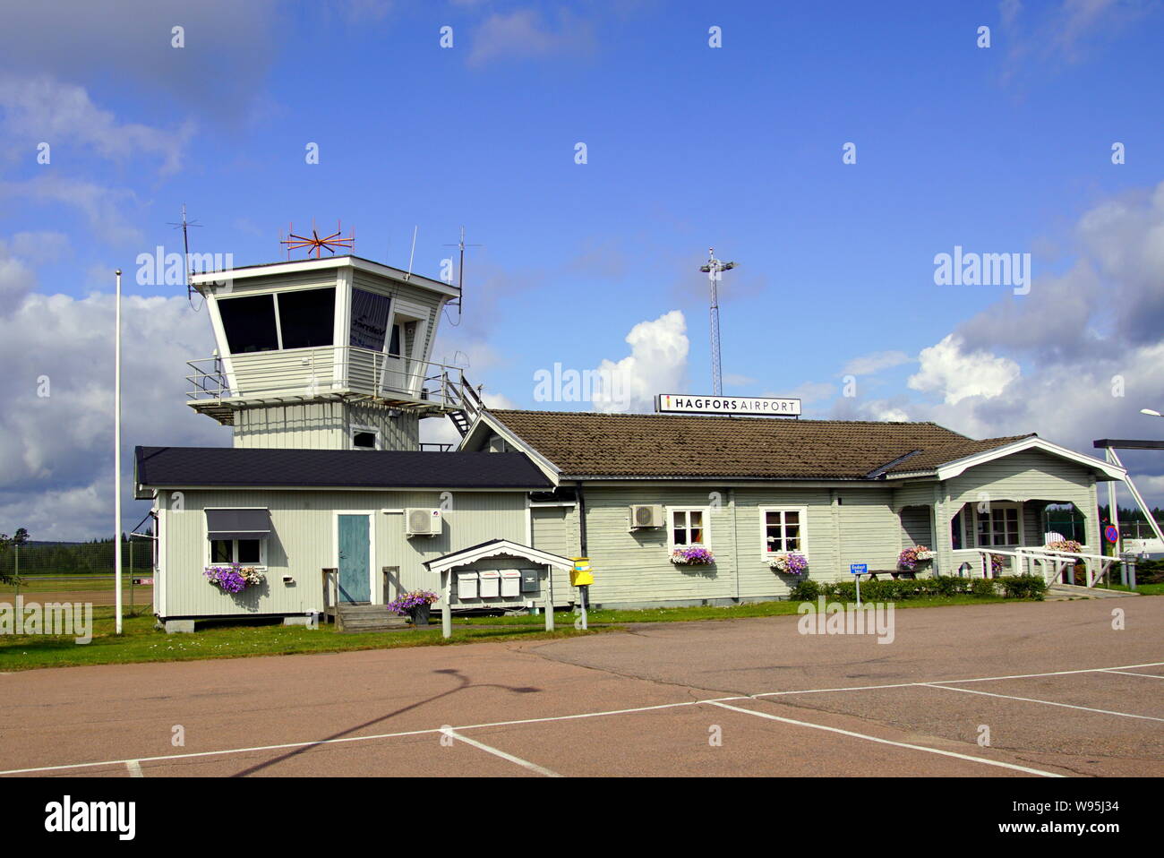Hagfors, Värmland County, Sweden -August 7, 2019: Terminal building and Air traffic control tower of Hagfors Airpot against a clouded blue sky. Stock Photo