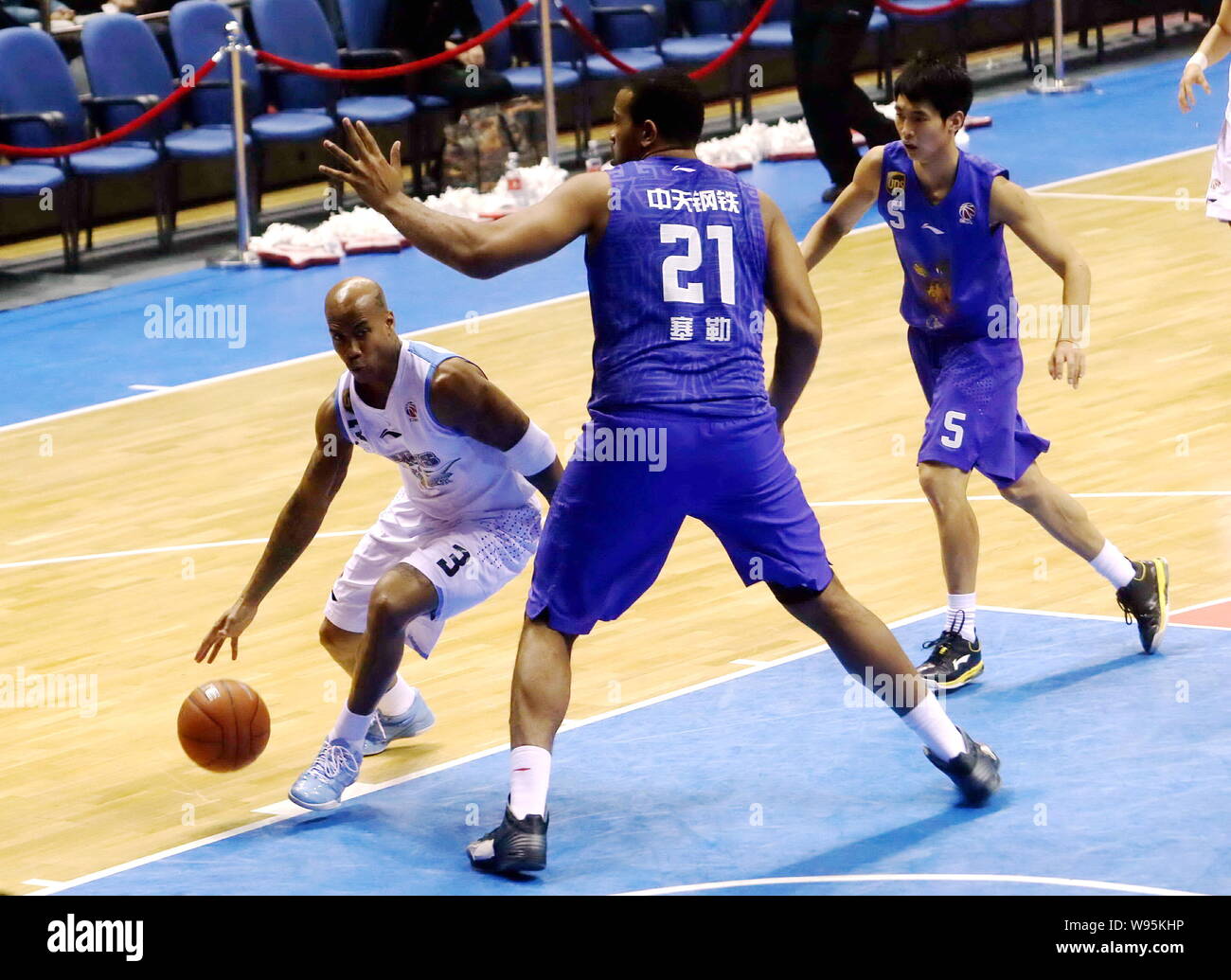 Stephon Marbury of the Beijing Ducks, left, challenges Garret Siler of the Jiangsu Dragons in their 11th round match during the 2012/2013 CBA season i Stock Photo