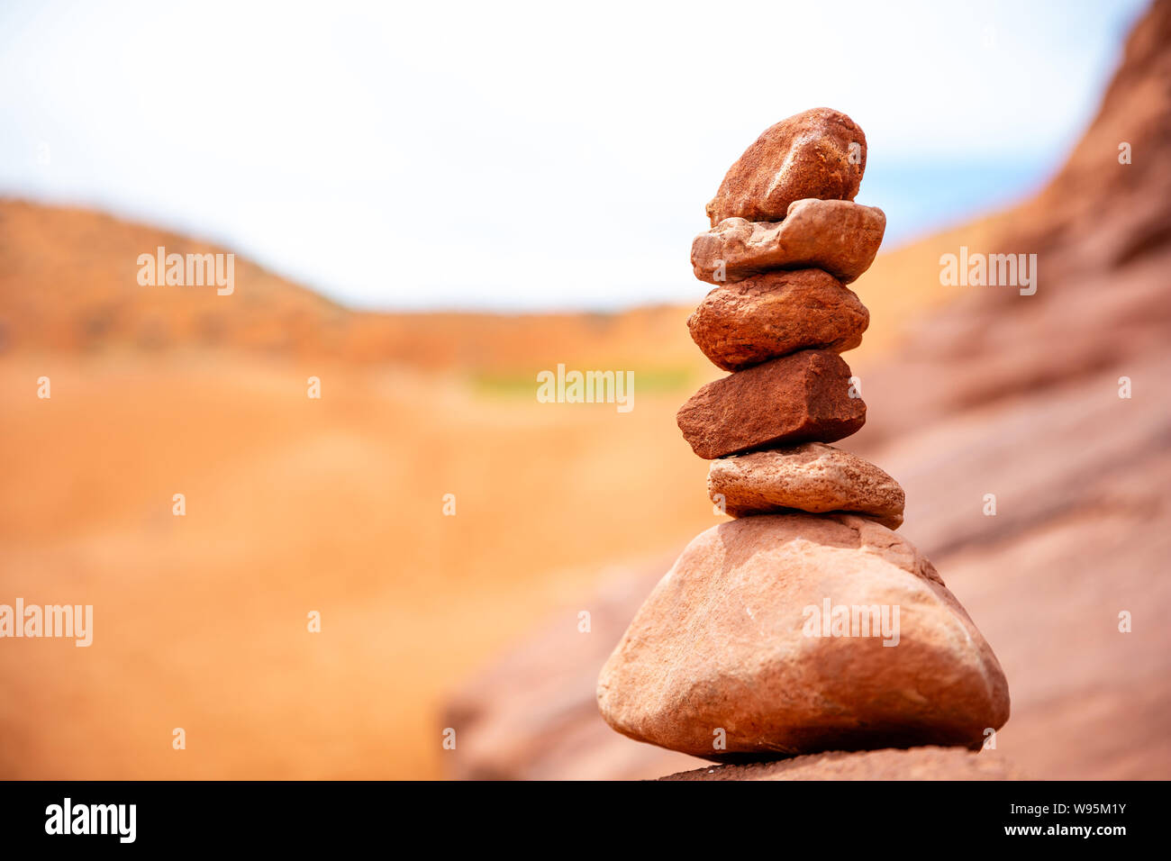 Harmony, balance in nature. Zen stones stack, blur red desert background. Antelope canyon Arizona, US. Stock Photo