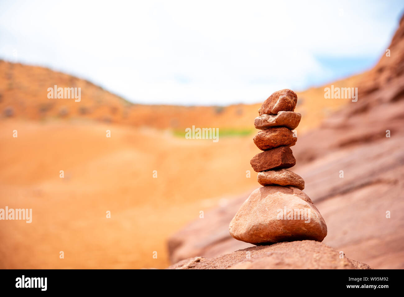 Harmony, balance in nature. Zen stones stack, blur red desert background. Antelope canyon Arizona, US. Stock Photo