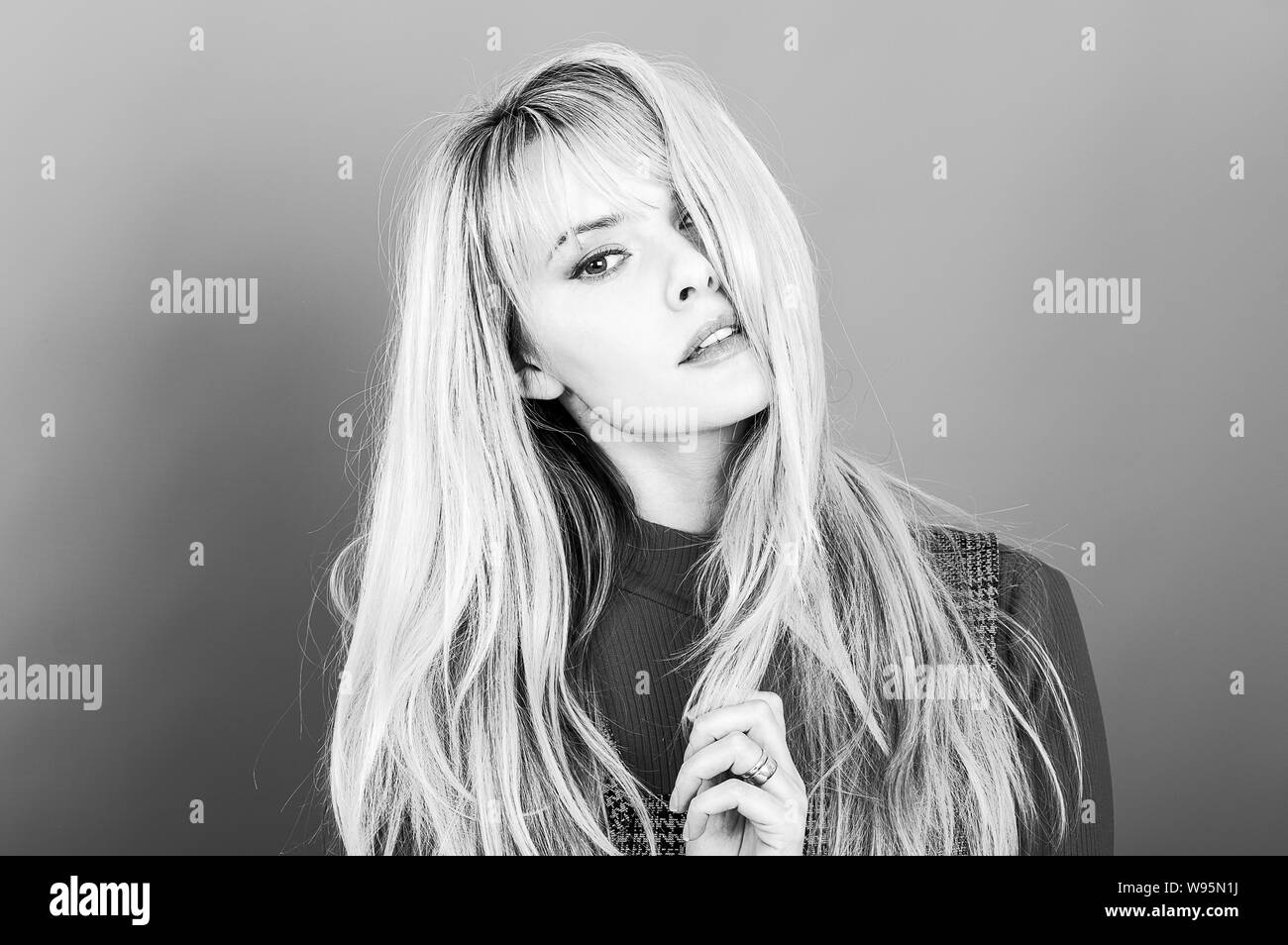 Portrait of an attractive woman, shot in the studio against a grey background Stock Photo
