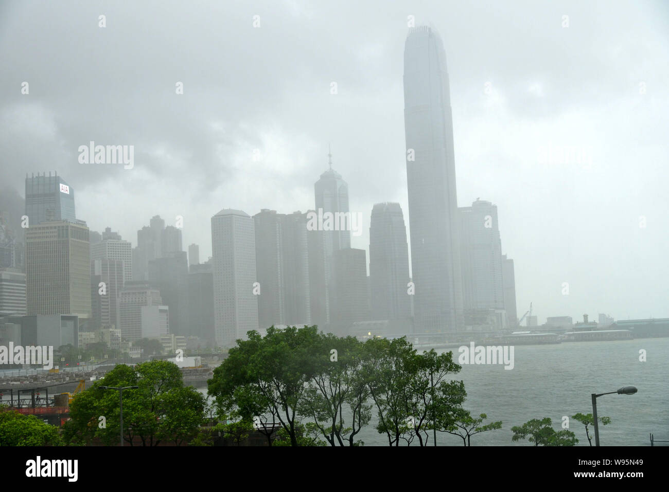 The Victoria Harbour is pictured in heavy rain under clouds caused by Typhoon Vicente in Hong Kong, China, 23 July 2012.   Hong Kong raised its highes Stock Photo