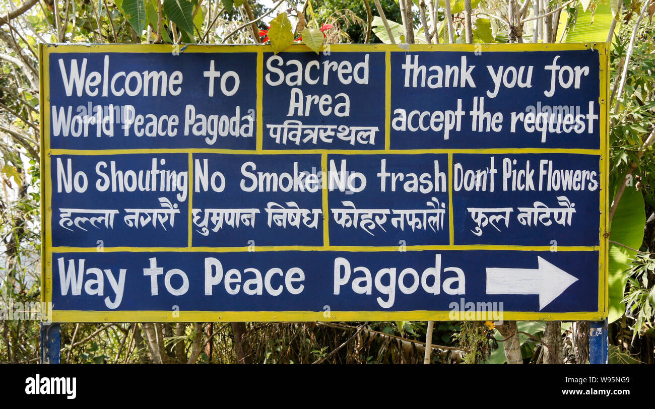 Bilingual sign (English and Nepali) on path to World Peace Pagoda in Pokhara, Nepal Stock Photo