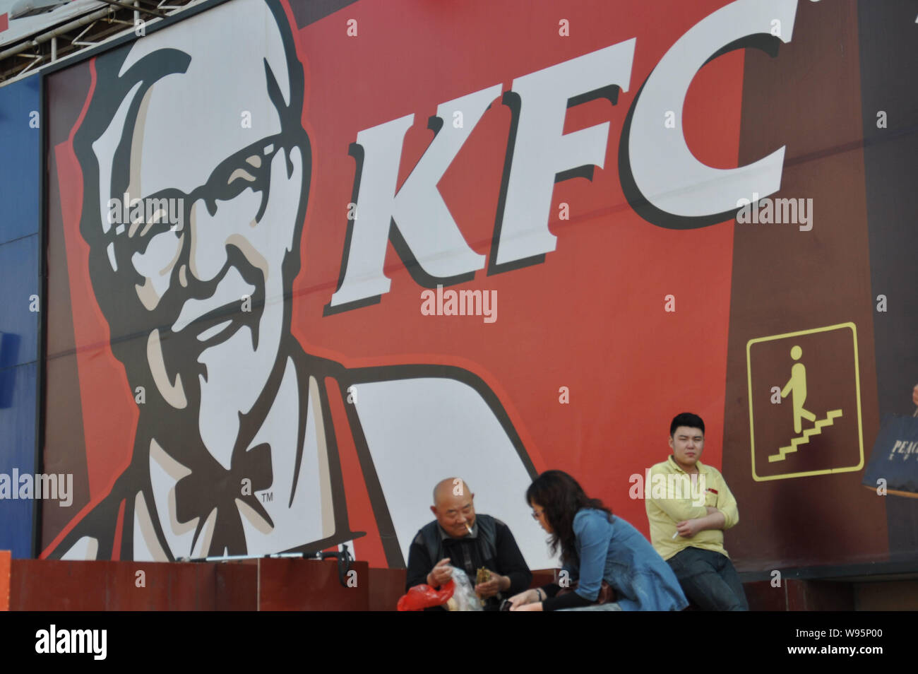 FILEPedestrians stand in front of an advertisement for KFC in