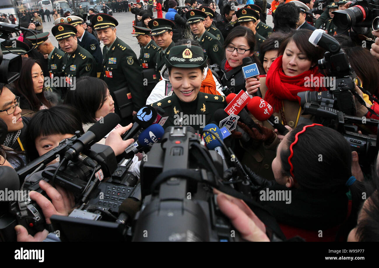 Photographers and journalists surround Chinese PLA singer and deputy