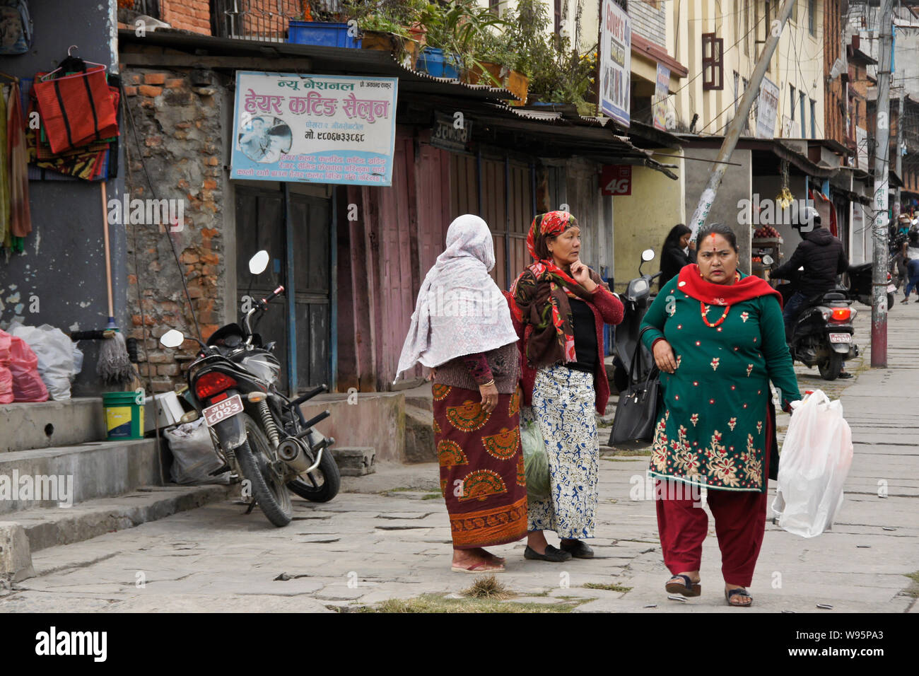 Women in traditional dress in the Old Bazaar area of Pokhara, Nepal Stock Photo