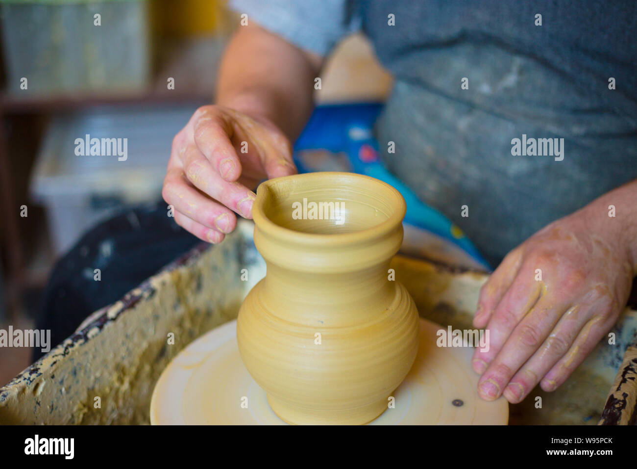 Professional male potter working with clay on potter's wheel Stock ...