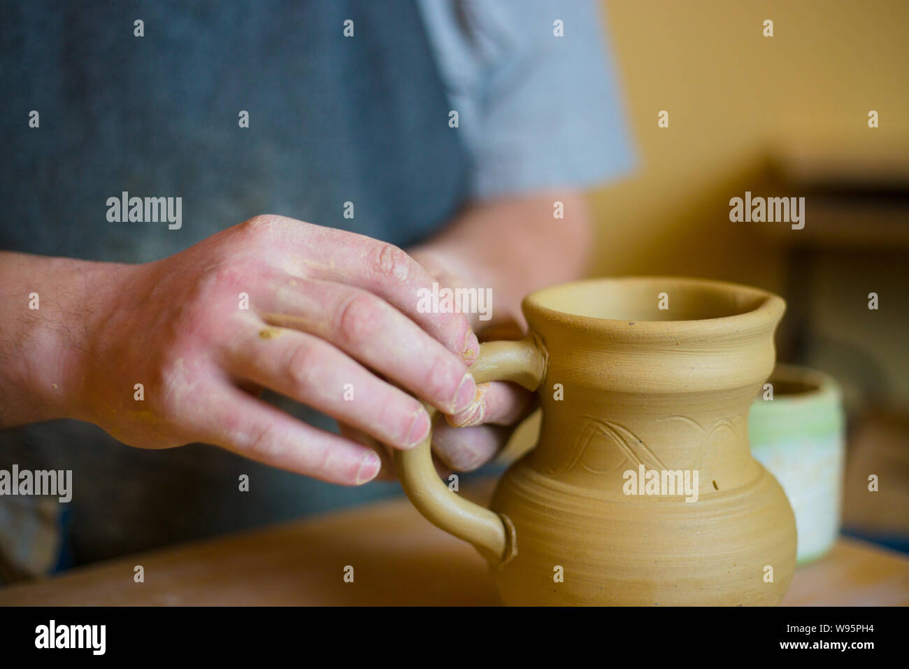 Professional male potter working in workshop, studio Stock Photo