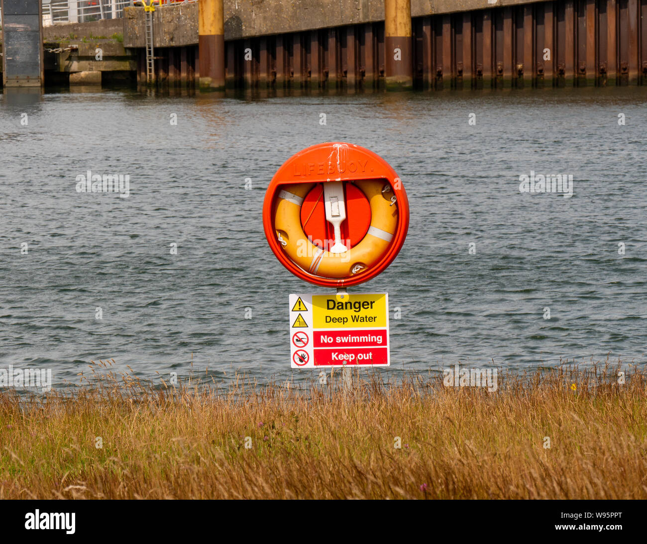 Lifebuoy on a stand with water in the background Stock Photo