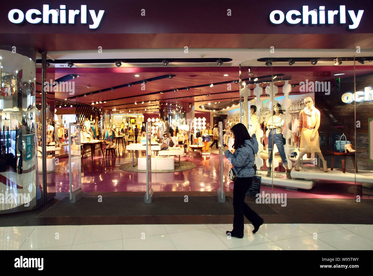 A pedestrian walks past an Ochirly store in Shanghai, China, 13