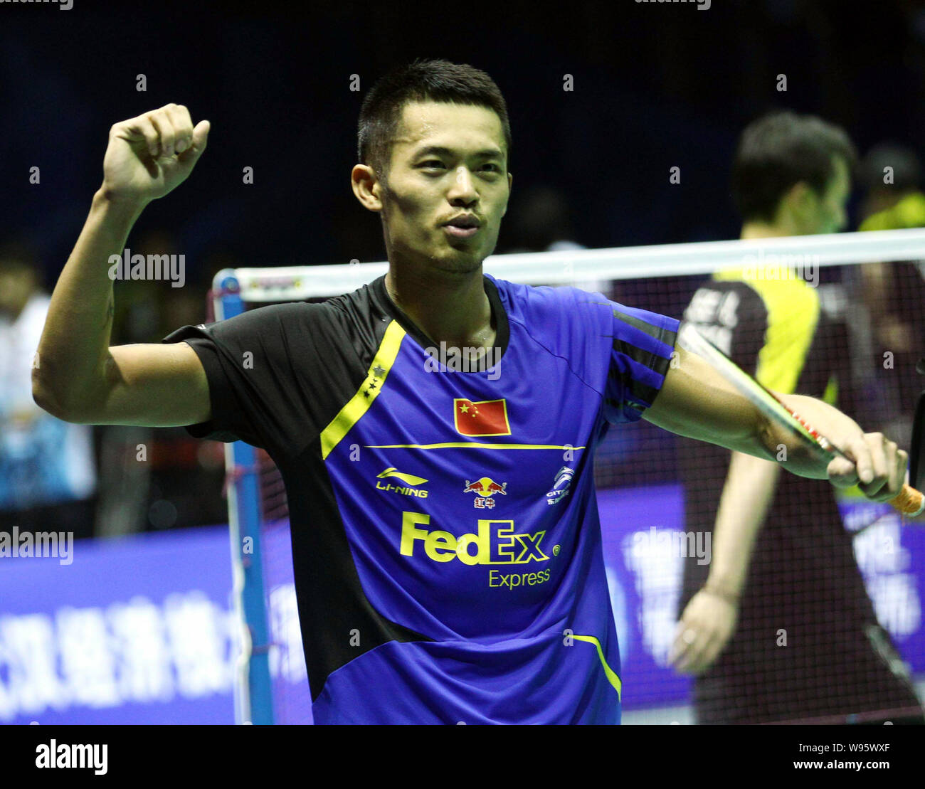 Lin Dan of China celebrates after defeating Lee Hyun-Il of South Korea during the final match of the Thomas Cup world badminton team championships in Stock Photo
