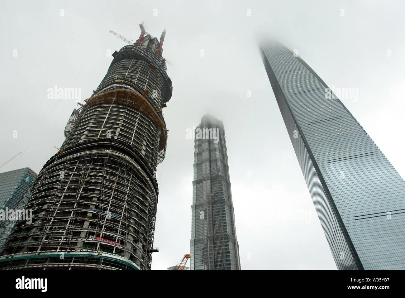 The Shanghai Tower, left, is under construction next to Jinmao Tower ...