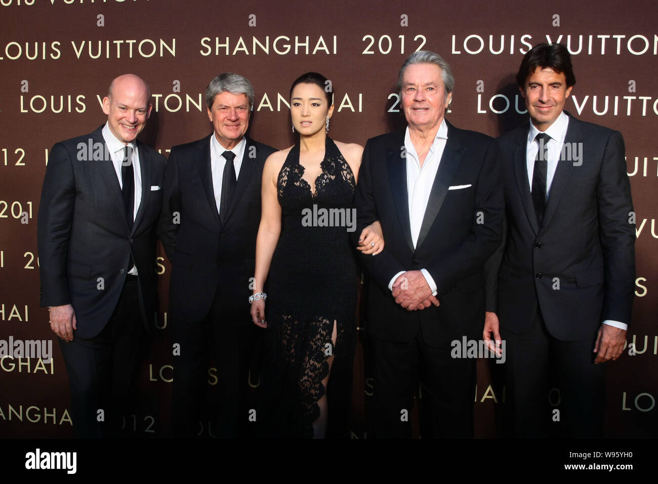 From left) Executive vice-president of LV Christopher Zanardi-Landi, CEO  Yves Carcelle, Chinese actress Gong Li , American actor Alain Delon, and son  Stock Photo - Alamy