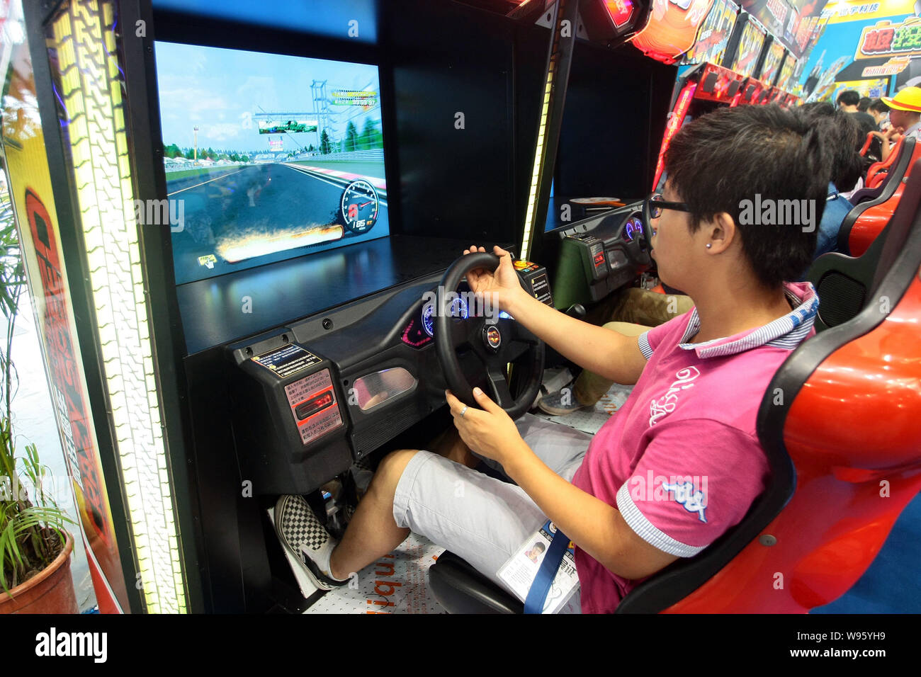 Visitors play electronic racing games during the 8th China International  Cartoon-Comic-Game Expo, known as CCG Expo 2012, in Shanghai, China, 12  July Stock Photo - Alamy