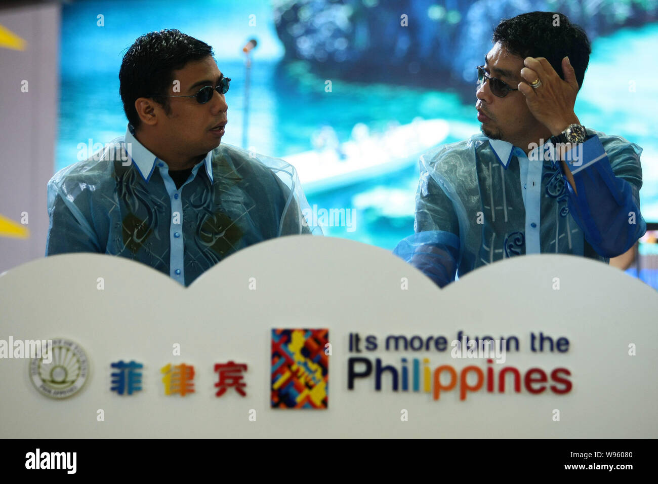 Exhibitors talk at the stand of Philippines during the 9th World Travel Fair in Shanghai, China, 11 May 2012.   Chinese travel agencies have suspended Stock Photo