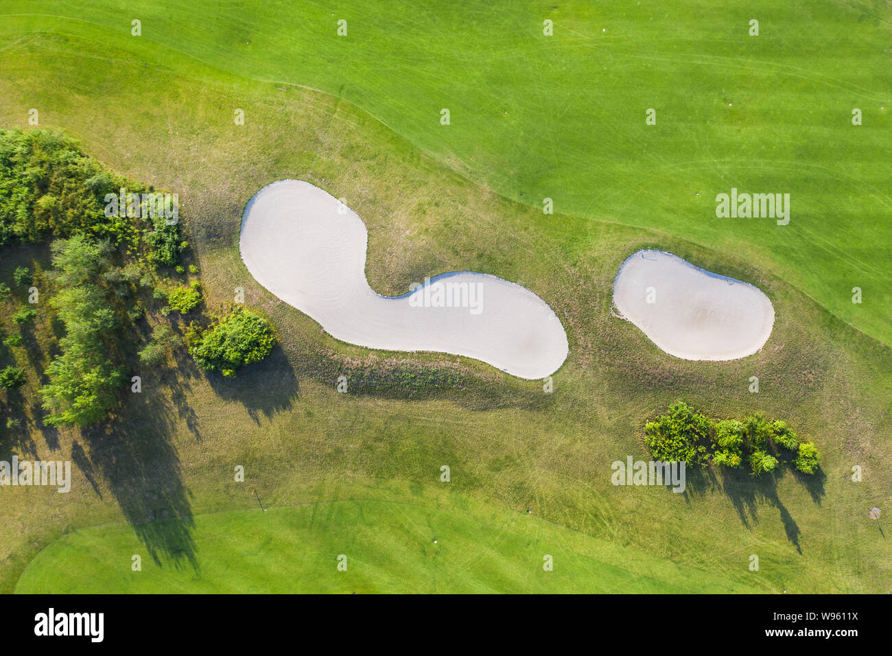 Aerial view of golf course. Drone or helicopter view of green field sand bunker Stock Photo