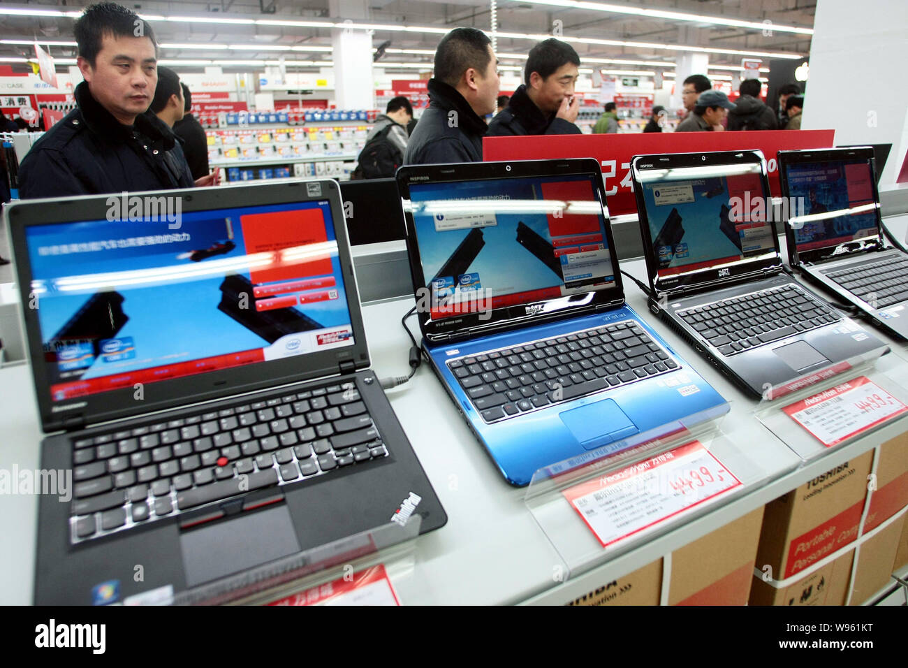 --FILE--Customers buy laptop computers at a Media Markt store in Shanghai, China, 9 December 2011.   Chinas retail sales in 2011 rose about 17 percent Stock Photo