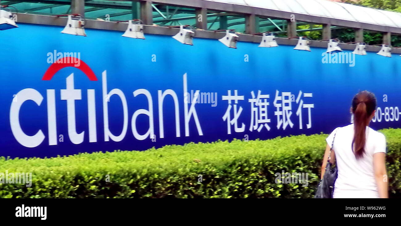 --File--A pedestrian walks past an advertisement for Citibank in Shanghai, China, 30 July 2011.   Citigroup Inc. has sold its 2.71 percent stake in Sh Stock Photo