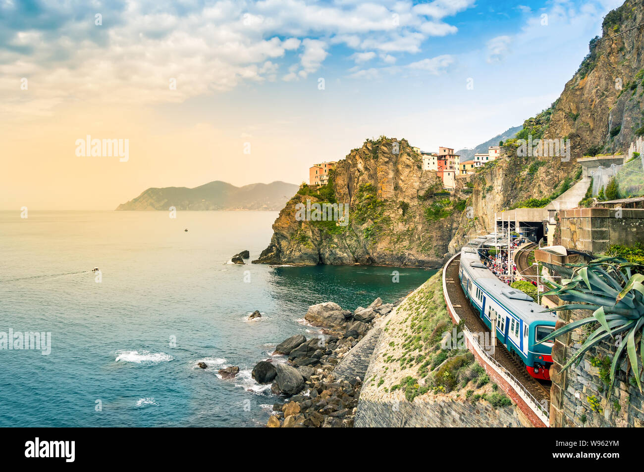 Manarola, Cinque Terre - train station in small village with colorful houses on cliff overlooking sea. Cinque Terre National Park with rugged coastlin Stock Photo