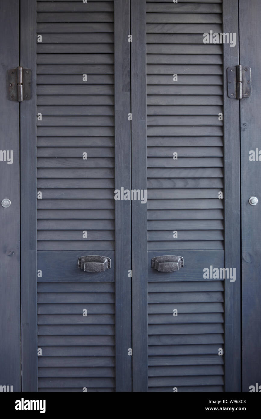 Close Up Dark Gray Shutter Doors With Frayed Metal Handles