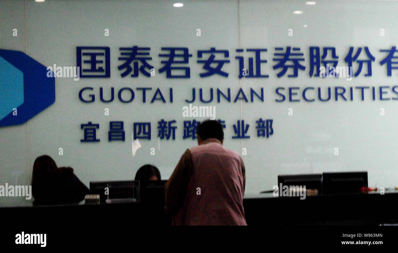 --File--A customer is seen at a branch of Guotai Junan Securities in Yichang, central Chinas Hubei province, 20 October 2011.   The number of securiti Stock Photo