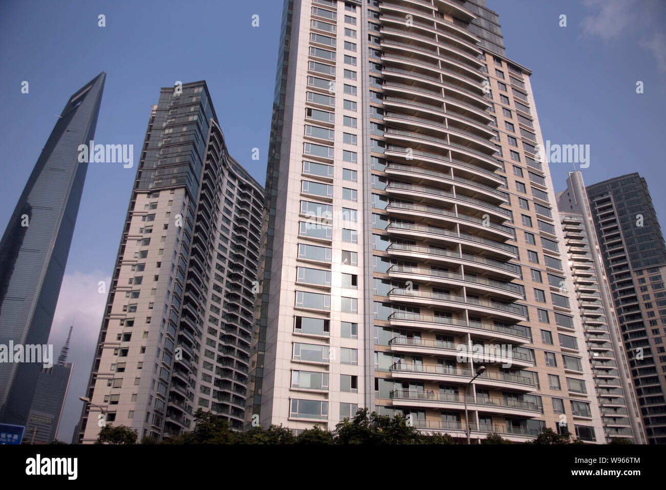 --FILE--Apartment buildings of Ocean One luxury residential project are pictured next to the Shanghai World Financial Center, left, in the Lujiazui Fi Stock Photo