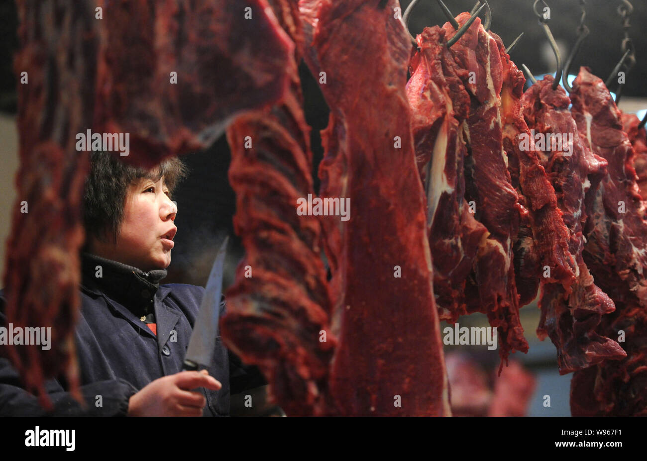 --FILE--A Chinese vendor sells beef at a free market in Nanjing city, east Chinas Jiangsu province, 12 January 2012.   Chinas consumer price index (CP Stock Photo