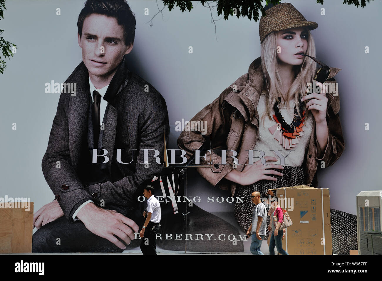 FILE--Pedestrians walk past an advertisement for Burberry in Lanzhou city,  northwet Chinas Gansu province, 30 May 2012. Burberry Group, the United  Stock Photo - Alamy