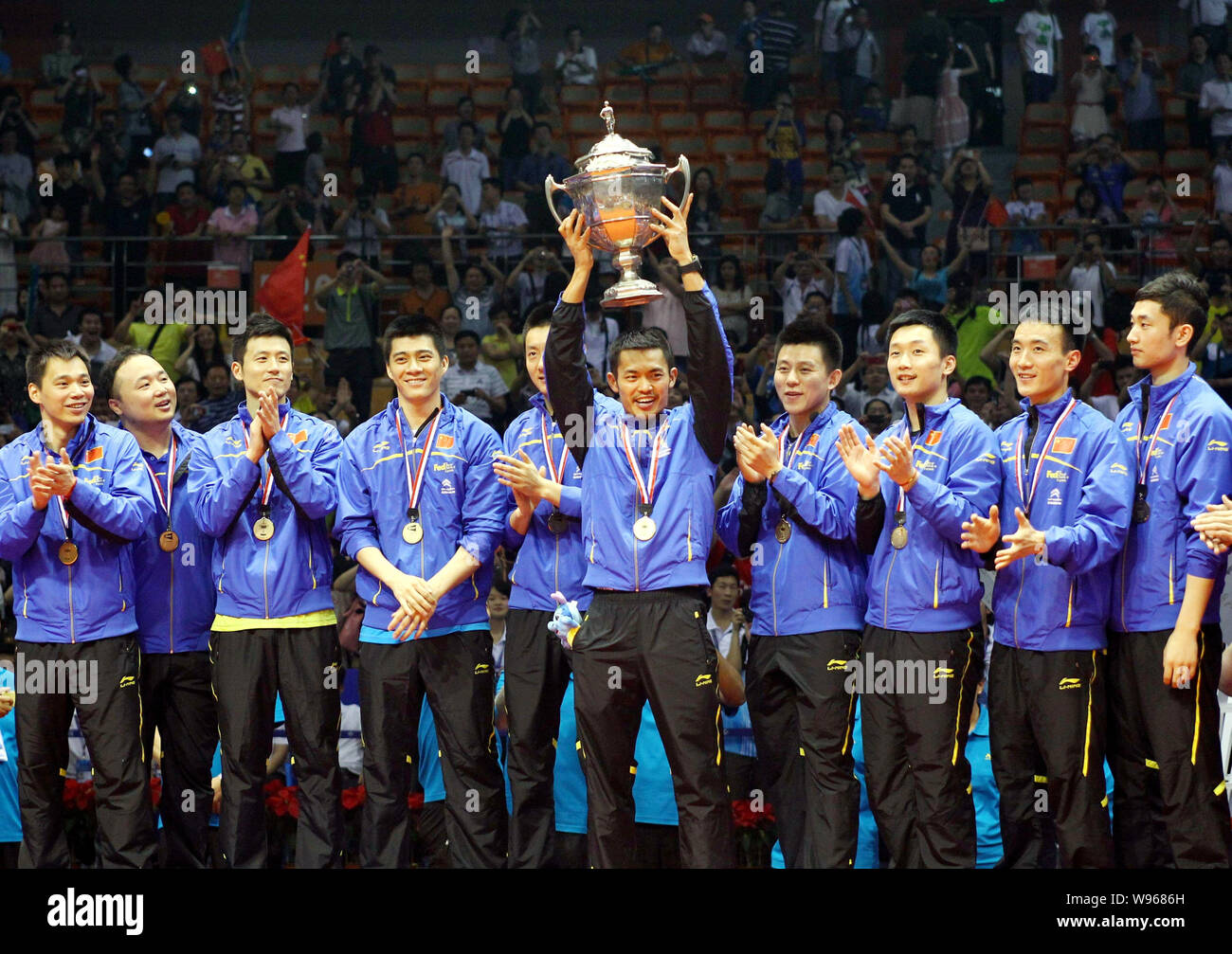 Lin Dan of China, fifth right, holds up the Thomas champion trophy at the award ceremony after defeating South Korea during the final match of the Tho Stock Photo
