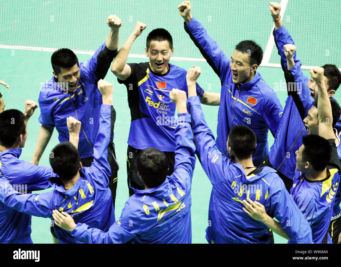 Chinese badminton players celebrate after defeating their English rivals in their Group A match during the Thomas Cup world badminton team championshi Stock Photo