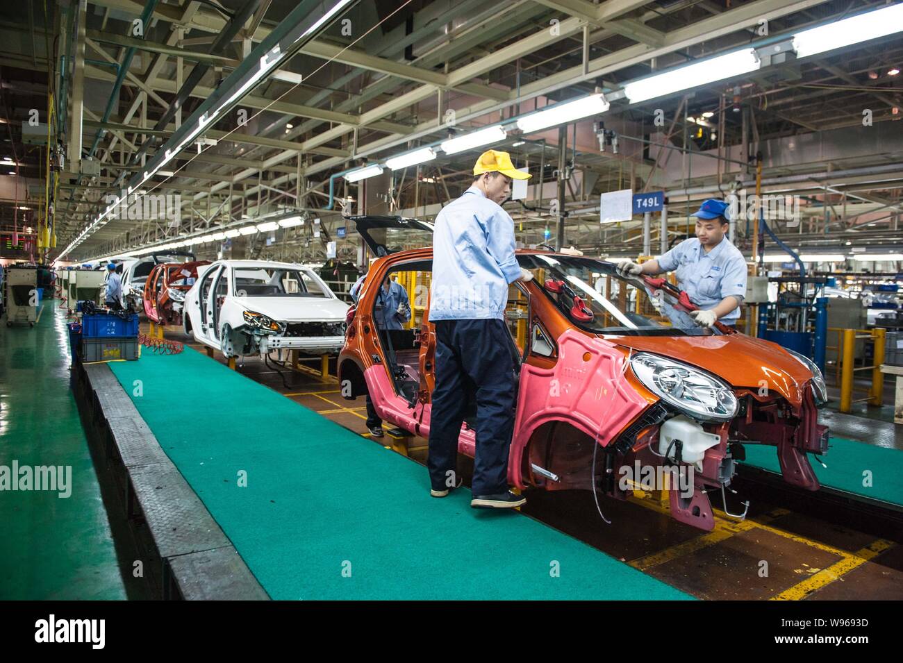--FILE--Chinese workers assemble cars on the assembly line at the auto ...