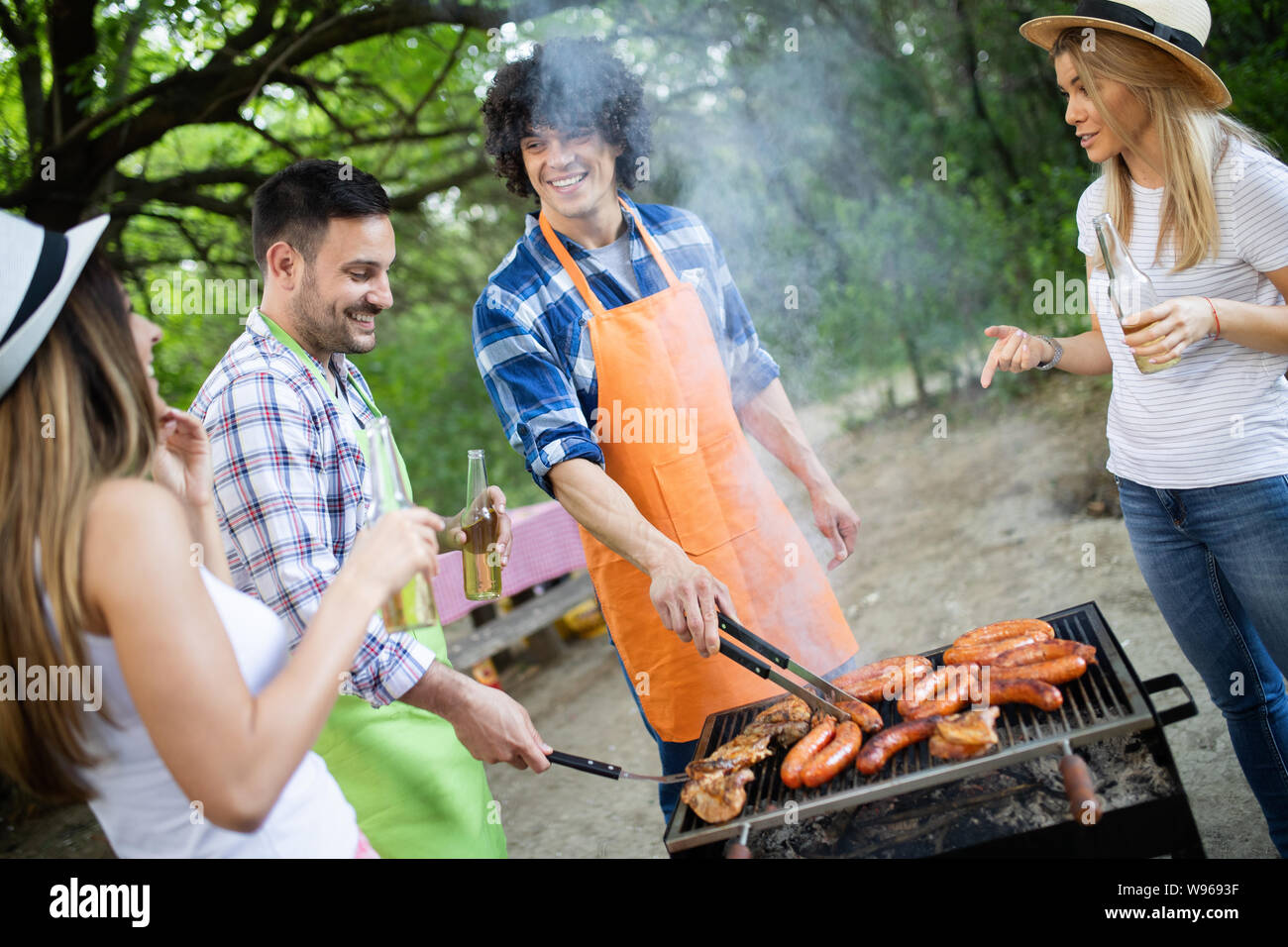 Group of friends having a barbecue party in nature Stock Photo - Alamy