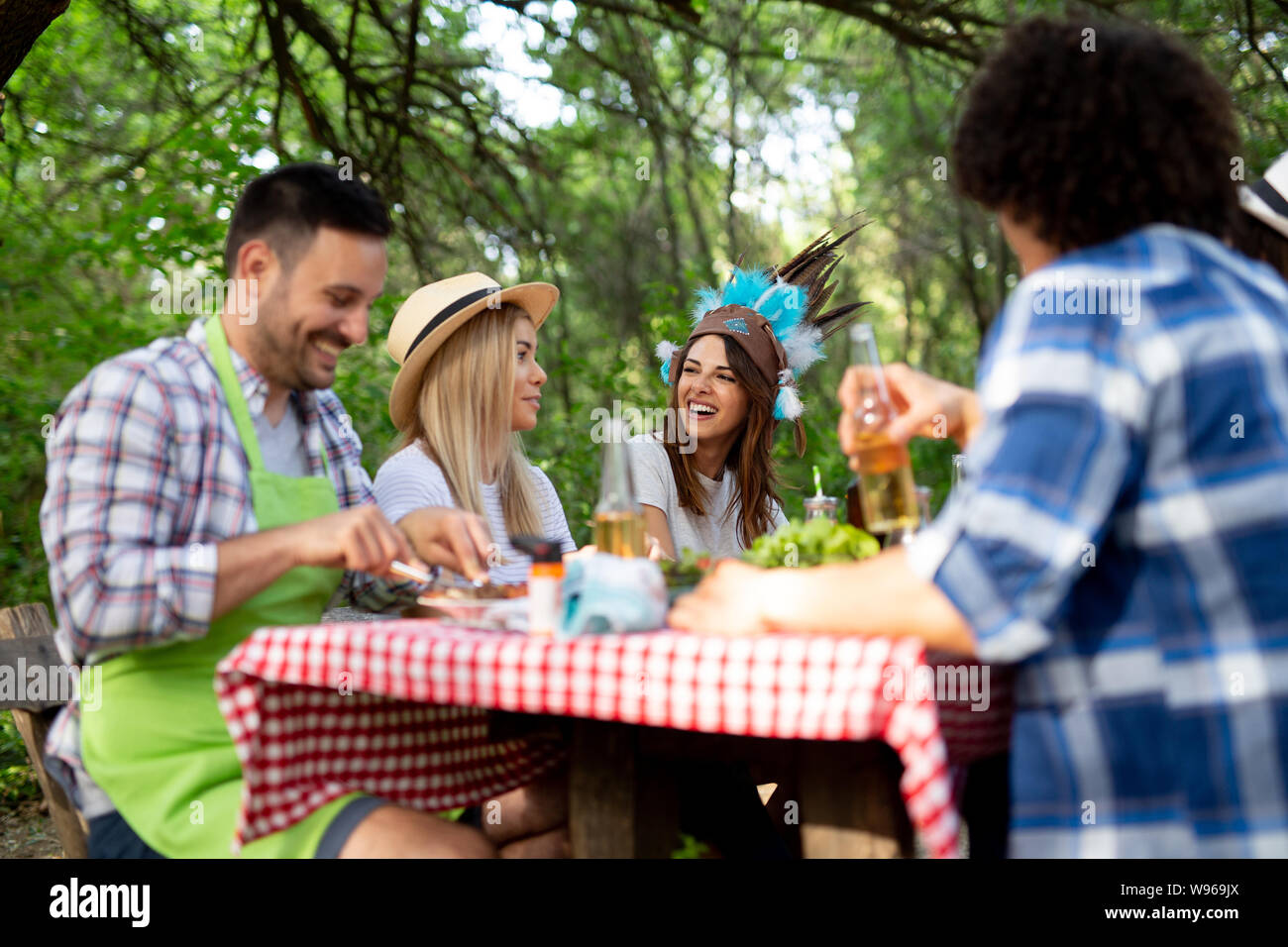 Group of happy friends having a barbecue party in nature Stock Photo ...