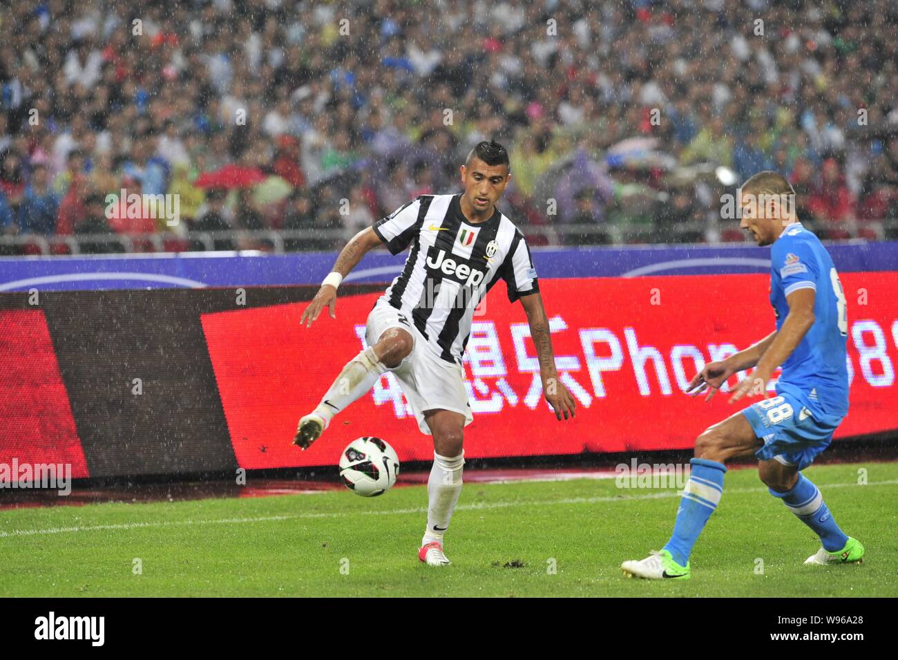 Arturo Erasmo Vidal Pardo of Juventus, left, challenges Gokhan Inler of Napoli during their Italian Super Cup football match at the National Stadium, Stock Photo