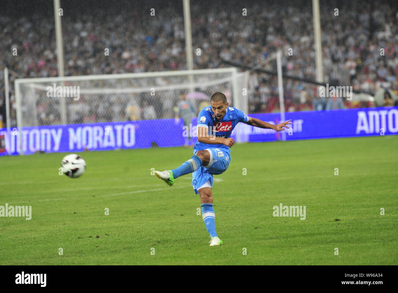 Gokhan Inler of Napoli passes the ball to a teammate against Juventus during their Italian Super Cup football match at the National Stadium, also know Stock Photo