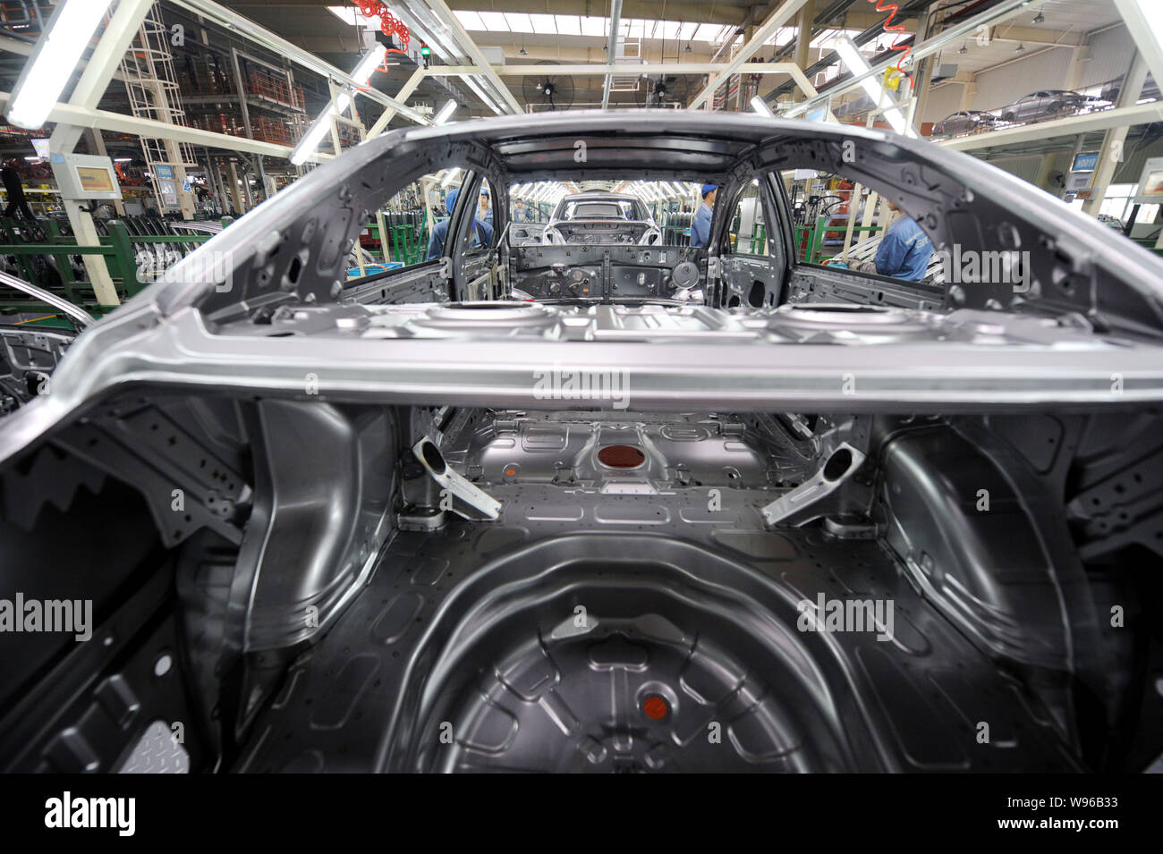 Chinese factory workers assemble Emgrand cars on the assembly line at ...