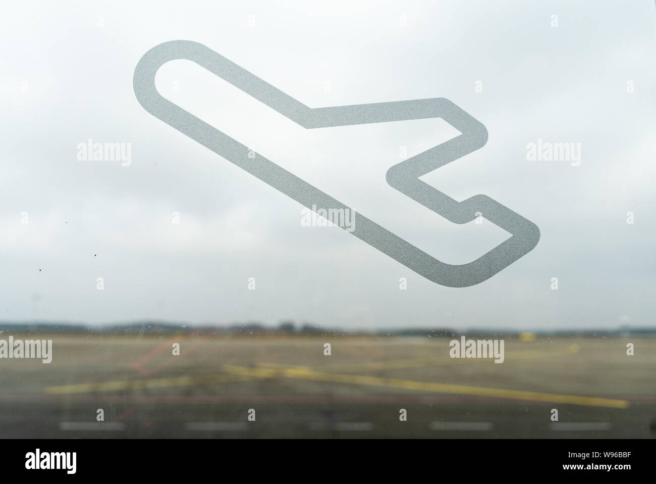 Concept of traveling. Plane on the window of the airport Stock Photo