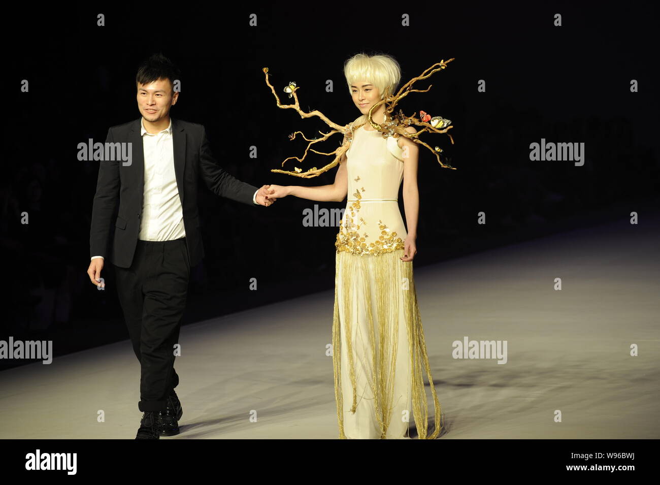 Hong Kong model and actress Janice Man walks the runway with a designer ...