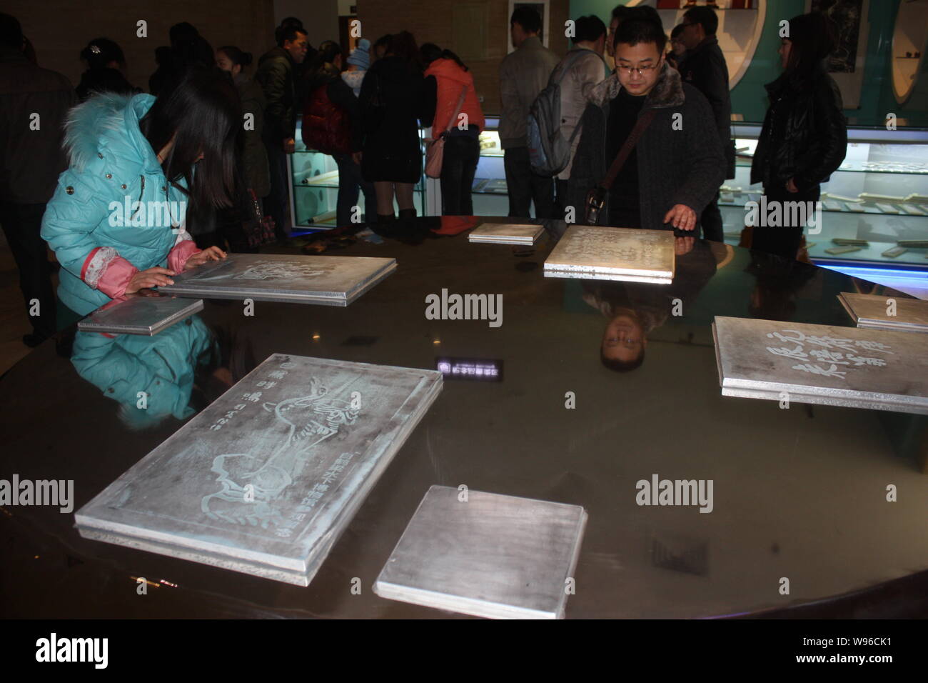 Visitors look at replicas of stone tablets at Baiheliang underwater museum in Chongqing, China, 12 March 2012.   Baiheliang, an ancient hydrological m Stock Photo