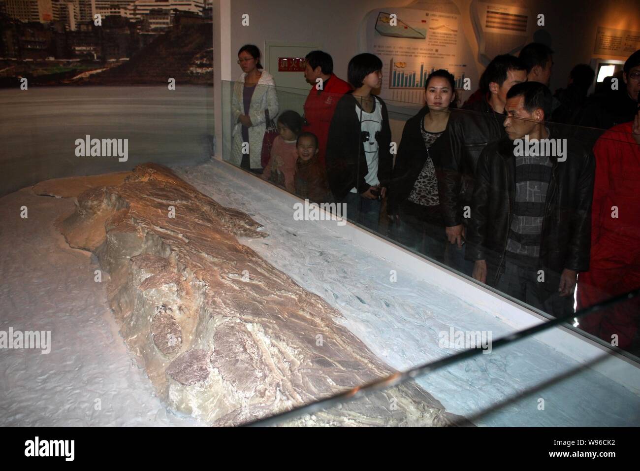 Visitors look at a model of Baiheliang at the underwater museum in Chongqing, China, 12 March 2012.   Baiheliang, an ancient hydrological marker datin Stock Photo